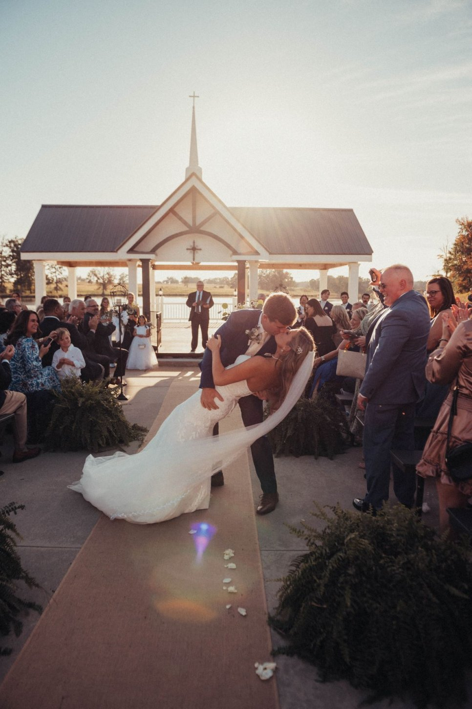 bride-groom-dip-kiss-waterfront-lakeside-chapel The Farm at Wolf Creek