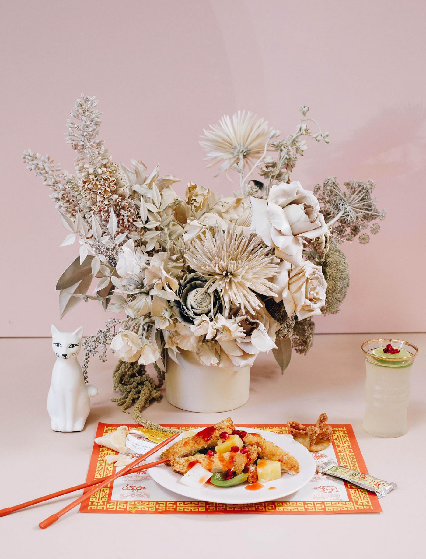 chinese takeout meal in front of neutral florals